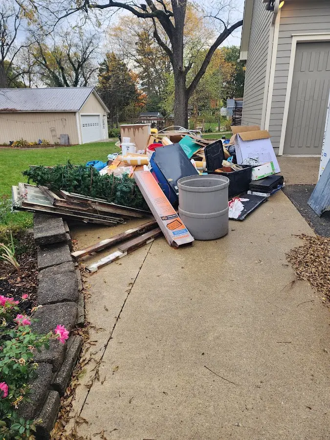 Dumpster being loaded with debris for Estate Cleanout Dumpster Rental in Rosedale
